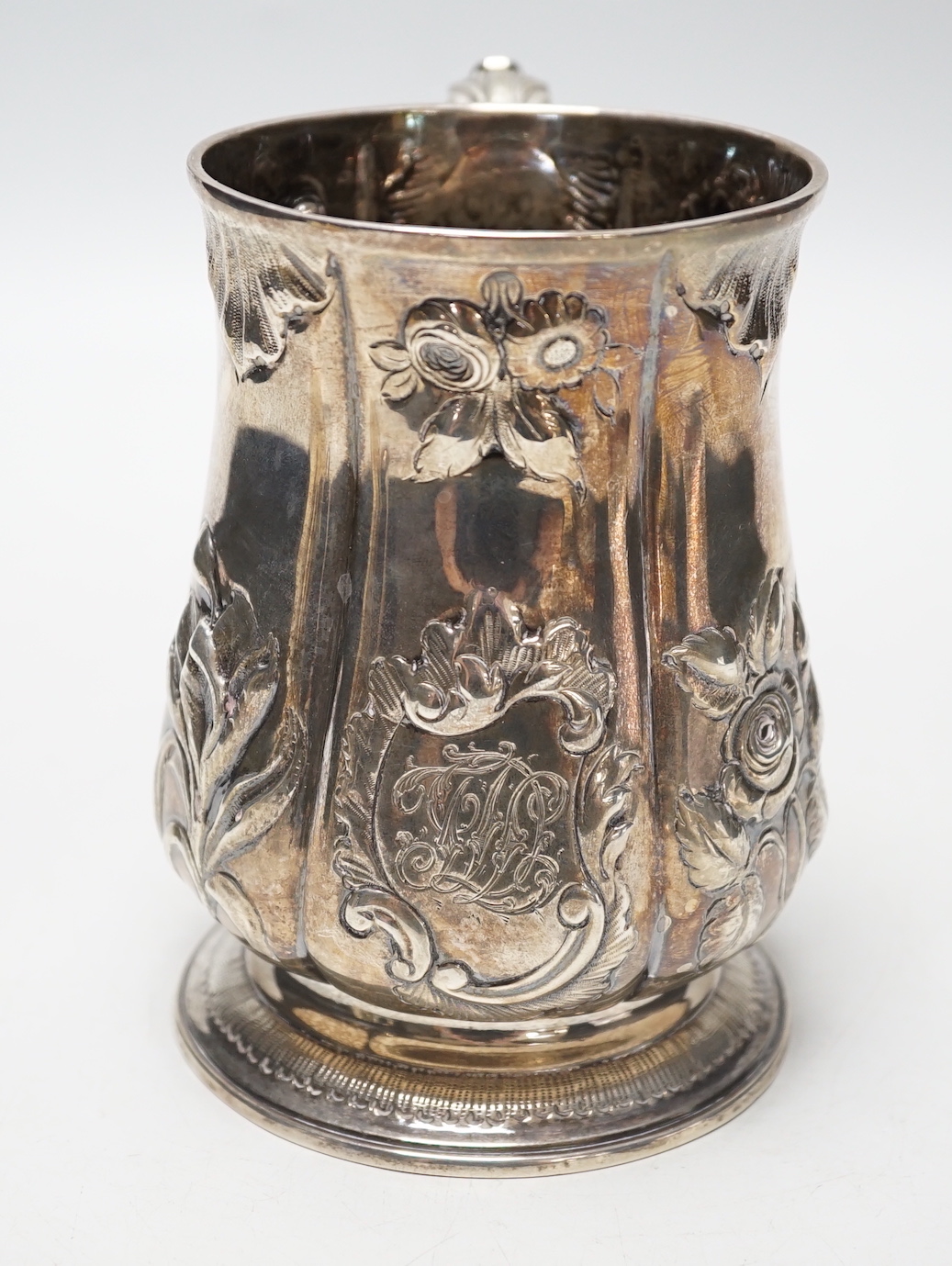 A George III silver baluster mug, with later embossed decoration, Joseph Steward?, London, 1763, 12.9cm, 11.8oz.